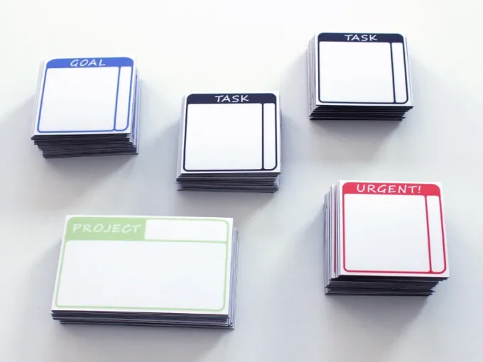 Custom dry-erase magnetic board with graphic design. Square sheets in various colors with blank spaces.