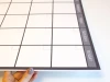 Magnetic dry-erase weekly planner board in English, featuring a simple grid with rectangles for each day.