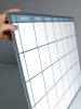 Magnetic dry-erase weekly planner board in English, rectangular with a grid for days.