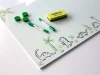 Dry-erase magnetic board for kids featuring dinosaur graphics on a white background.
