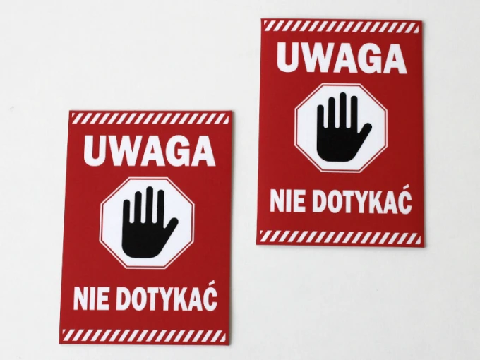 Caution sticker - Graphic design. Red background with white text and a black hand in the shape of a stop sign.