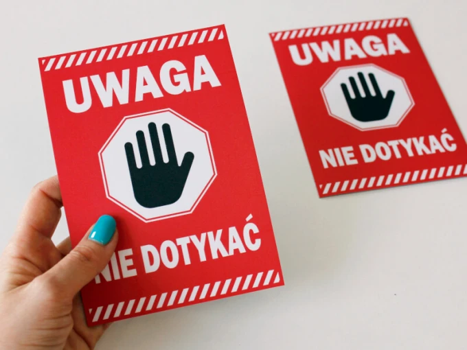 Caution sticker - Do not touch. Red background with white text and hand symbol.