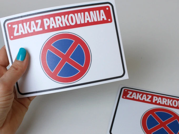 No Parking Sticker N039 - Graphic design with red text on a white background and a blue prohibition sign.