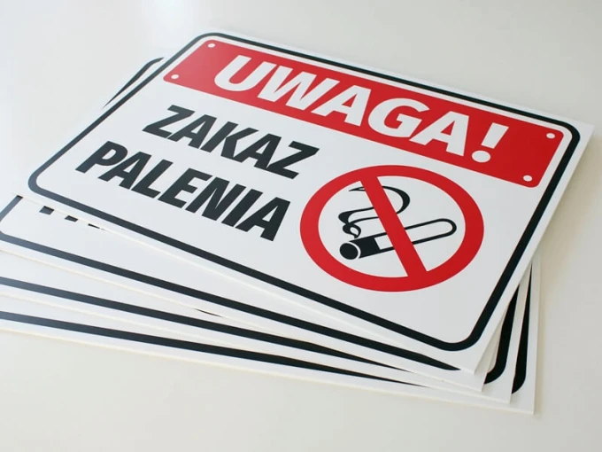 No Smoking Sign - Graphic Design. Red text on a white background with a crossed-out cigarette symbol.
