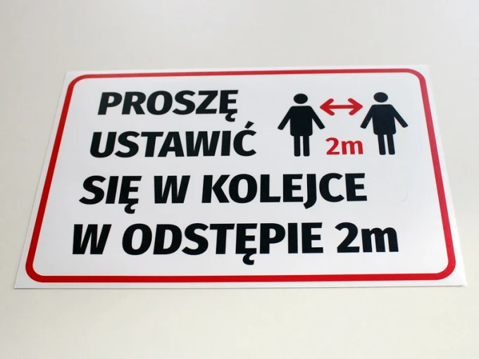 Please wait in line 2m apart - Graphic design featuring people and arrows.