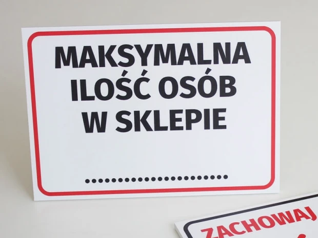 Maximum number of people in the store - Graphic design. Simple sign with large black letters on a white background.