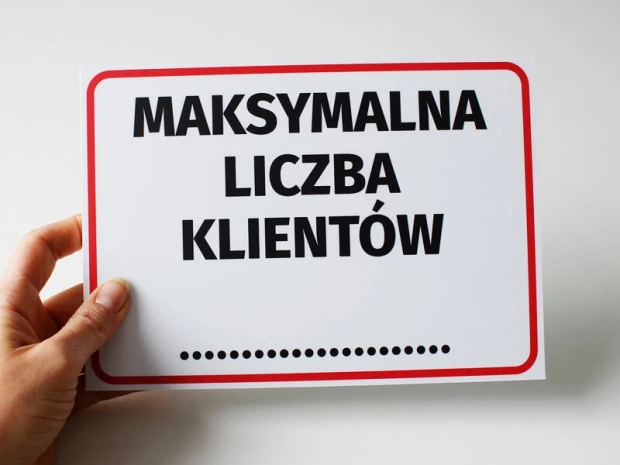 Maximum number of customers sign - Graphic design. Rectangular sign with large text on a white background and red border.