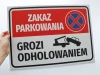 No Parking Sign - Tow Away Zone. Red background with white text and towing symbol.