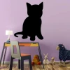 Magnetic chalkboard for kids featuring a cat design, perfect for a child\'s room with purple walls and light furniture.