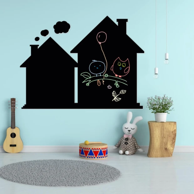 Chalkboard magnetic board for kids\' room. Light-colored walls, carpeted floor, and furniture included.