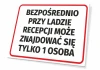 Sign: Only 1 person allowed directly at the reception desk - Graphic design. Rectangular sign.