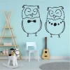 Owl wall sticker 2549 - Decor for a child\'s room with light walls, wooden furniture, and toys.
