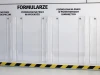 Hanging A4 pocket made of plexiglass, 4cm deep, for vertical/horizontal use - Office arrangement with light walls and simple furniture.