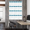 Universal yearly dry-erase calendar 352 - Office setup with gray-beige walls and wooden accents.