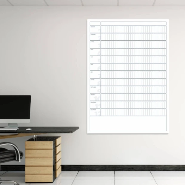 Magnetic dry-erase calendar board in English, ideal for office decor with light-colored walls and furniture.