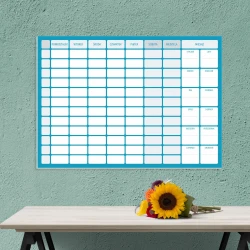 Weekly dry-erase planner with annual planner 267 - Office setup. Green wall with planner displayed.