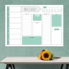 Weekly planner dry-erase board 411 - Office setup with green walls and a light-colored table adorned with flowers.