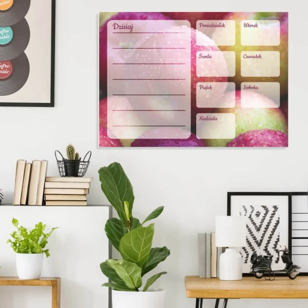 Weekly planner whiteboard with apple design - Office setup featuring light-colored walls, modern furniture, and plants.