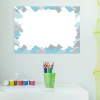 Dry-erase board for kids with cloud design in shades of blue and gray surrounding a blank space.