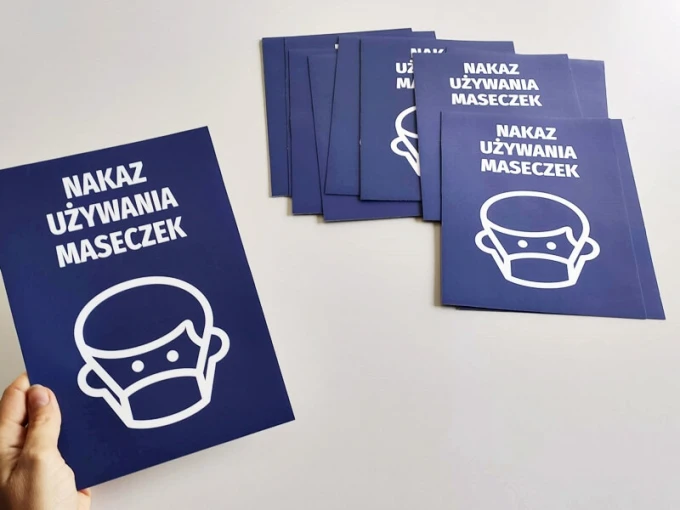 Mask mandate sticker - Graphic design featuring a person wearing a mask on a dark blue background.