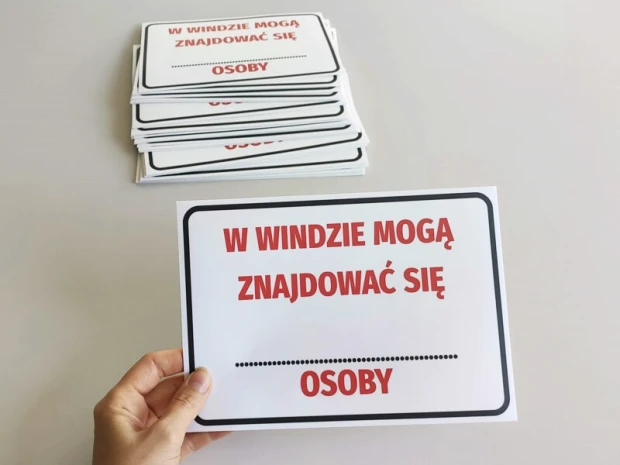 Sticker: Maximum number of people in the elevator - Graphic design. Text in large red letters on a white background.