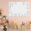Dry-erase magnetic board for kids featuring rabbits, perfect for a child\'s room with soft pink walls.