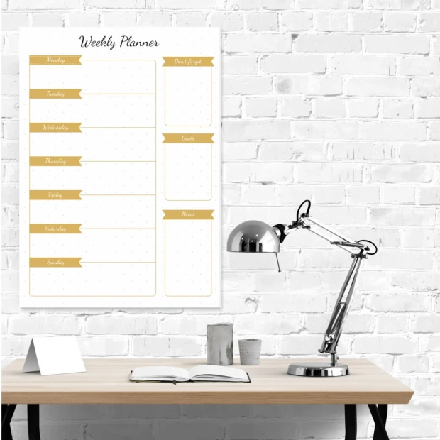 Magnetic dry-erase weekly planner 407 - Office setup with white walls, wooden table, and metal lamp.