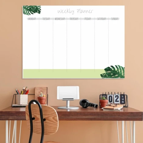 Magnetic dry-erase weekly planner for office use. Brown walls and wooden furniture.