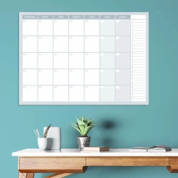Magnetic dry-erase weekly planner board 512 - Office setup with blue walls and a table stacked with books.