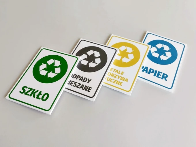 Recycling bin signs - Graphic design. Four rectangular signs with recycling icons in various colors.