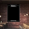 Chalkboard with bistro print for restaurant decor. Dark brick walls, wooden furniture, and lighting.