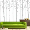 Tree wallpaper 049 - Living room decor with light-colored walls and furniture in shades of green and brown.