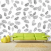 Feather wallpaper 034 - Living room setup with a green sofa against a white wall featuring black leaves.