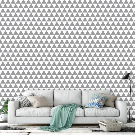 Triangle wall wallpaper 038 - Living room setup with gray walls and a light sofa adorned with patterned cushions.