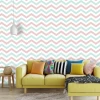 Geometric pattern wallpaper 061 - Living room setup with a yellow sofa and colorful cushions.