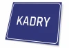 Graphic sign for "KADRY" on a simple rectangular dark blue background.