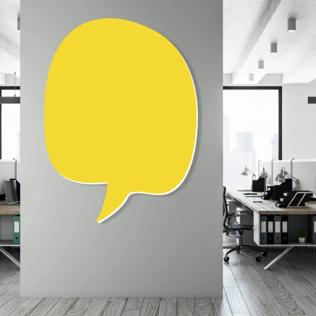 Magnetic whiteboard for office use, featuring a modern design with light-colored walls and furniture.