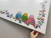 Magnetic whiteboard for kids with colorful birds design on a white background.