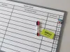 Magnetic task board with a graphic design. Simple grid with fields for writing.