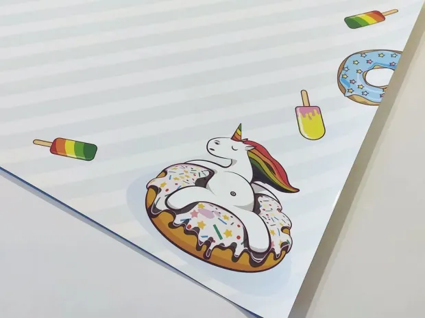 Dry-erase magnetic board for kids featuring a unicorn design on a donut.
