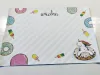 Dry-erase magnetic board for kids featuring a unicorn design with colorful donuts on a white background.