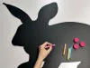 Chalkboard magnetic board for kids featuring a rabbit design with cut-out ears and crayons nearby.