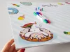 Dry-erase magnetic board for kids featuring a unicorn design on a donut.