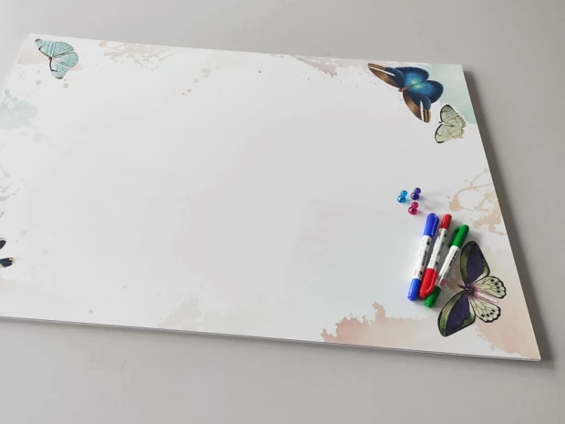 Dry-erase magnetic board for kids with butterfly design. Colorful butterflies on a white background.