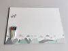 Magnetic dry-erase board for kids featuring animals and mountains, with clouds visible at the bottom.