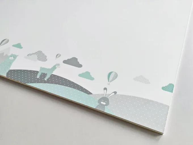 Dry-erase magnetic board for kids featuring animals and mountains, with clouds and animals in the background.