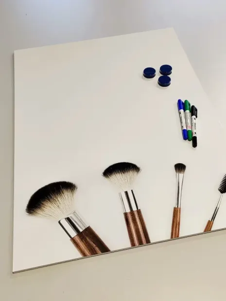 Magnetic whiteboard for makeup artists featuring a graphic design with makeup brushes on a white background.