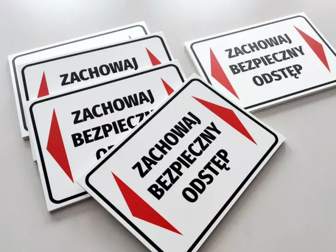 Keep a safe distance sign - Rectangular sign with white background, red arrows, and black text.