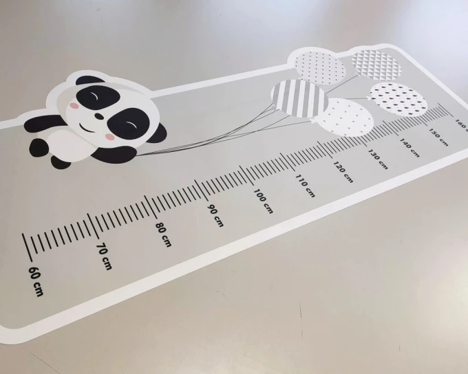 Child growth chart sticker with panda holding balloons and measurement scale.