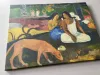 Reproduction of Arearea by Paul Gauguin. Two figures sit against greenery, with a moving dog and colorful patches.